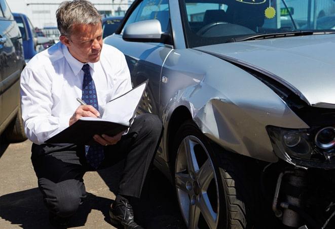 car insurance policy on a desk with car keys